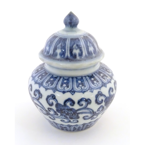 25 - A Chinese blue and white Ming style lidded ginger jar with an associated lid, decorated with stylise... 