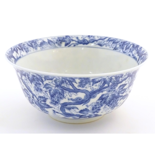 27 - A Chinese blue and white bowl decorated with vine leaves and grapes. Character marks under. Approx. ... 