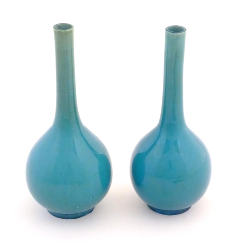 44 - Two Oriental bottle vases with a turquoise ground. Largest approx. 9 1/2