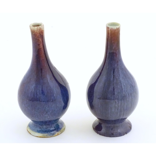 38 - A pair of Oriental high fired bottle vases. Approx. 5 3/4