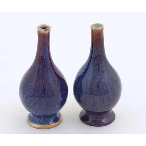 38 - A pair of Oriental high fired bottle vases. Approx. 5 3/4
