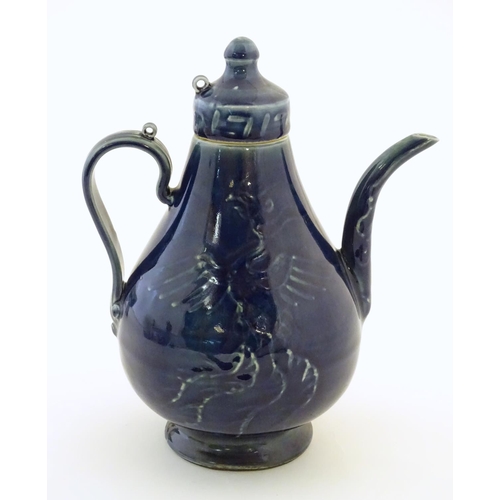 12 - A Chinese pear shaped teapot with phoenix bird decoration to body. Approx. 8 3/4