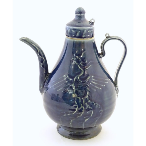 12 - A Chinese pear shaped teapot with phoenix bird decoration to body. Approx. 8 3/4