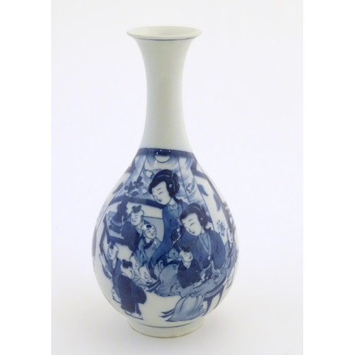 41 - An Oriental blue and white bottle vase with a flared rim decorated with two women and children in an... 