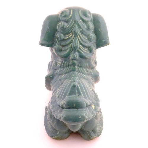 71 - An Oriental model of a guardian lion with a turquoise glaze. Approx. 16