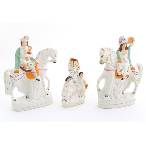 94 - Three Victorian Staffordshire figures depicting male and female Scottish figures on horseback, and a... 