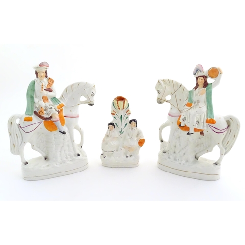 94 - Three Victorian Staffordshire figures depicting male and female Scottish figures on horseback, and a... 