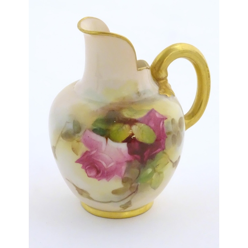 144 - A Royal Worcester flatback jug with a shaped spout, with painted decoration depicting rose flowers a... 
