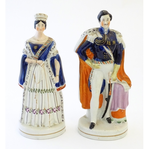 102 - Two Victorian Staffordshire pottery figures depicting Queen Victoria, and Prince Albert. Largest app... 