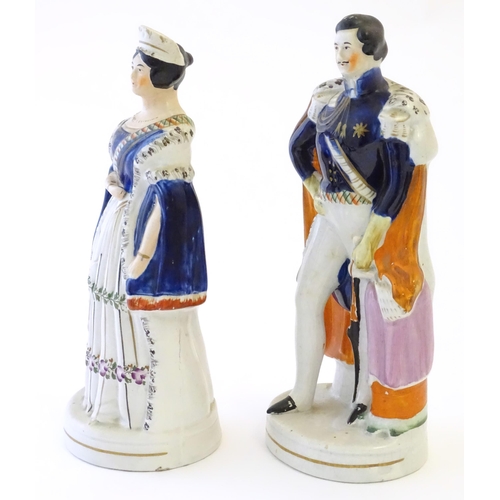 102 - Two Victorian Staffordshire pottery figures depicting Queen Victoria, and Prince Albert. Largest app... 