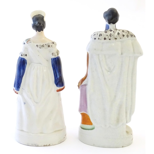 102 - Two Victorian Staffordshire pottery figures depicting Queen Victoria, and Prince Albert. Largest app... 