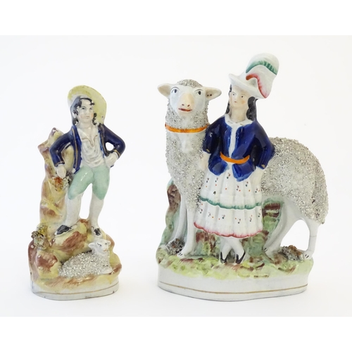 103 - Two Victorian Staffordshire pottery figures depicting a girl with a large sheep, and young shepherd ... 