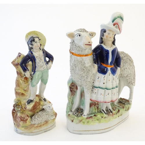 103 - Two Victorian Staffordshire pottery figures depicting a girl with a large sheep, and young shepherd ... 