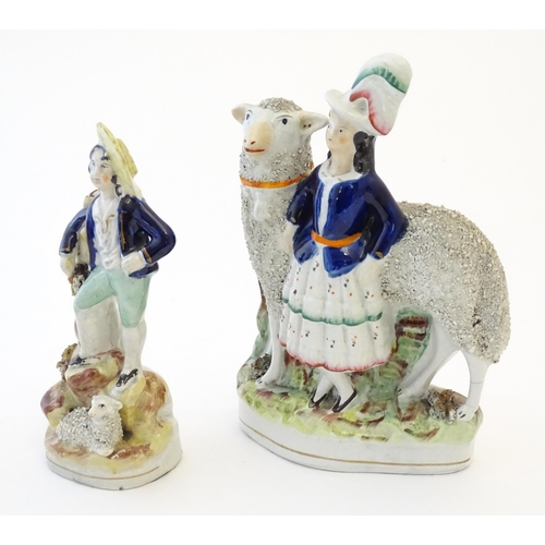 103 - Two Victorian Staffordshire pottery figures depicting a girl with a large sheep, and young shepherd ... 