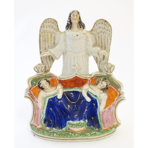 104 - A Victorian Staffordshire pottery flat back figural group depicting an angel watching over two Royal... 