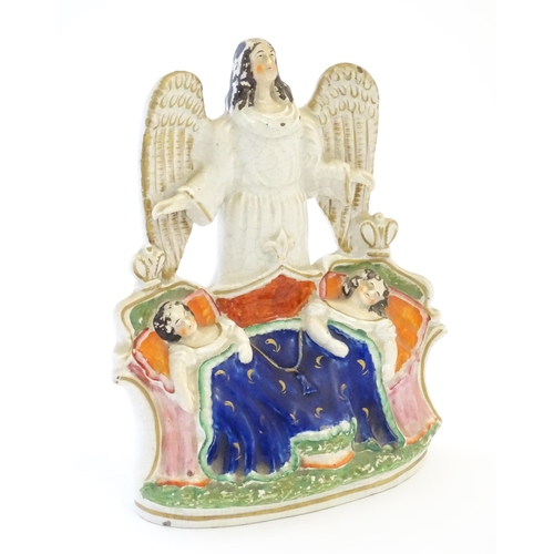 104 - A Victorian Staffordshire pottery flat back figural group depicting an angel watching over two Royal... 