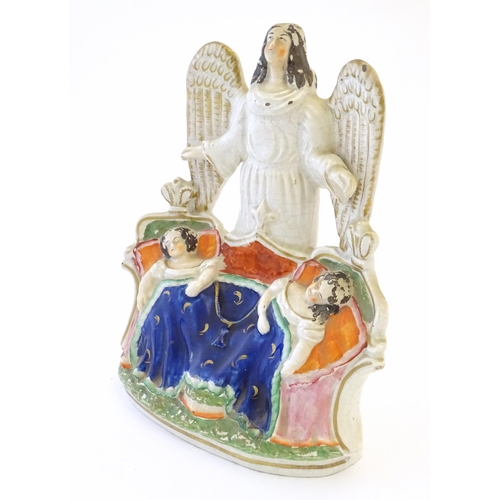 104 - A Victorian Staffordshire pottery flat back figural group depicting an angel watching over two Royal... 