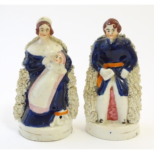 105 - A pair of Victorian Staffordshire pottery figures depicting Queen Victoria seated holding a child, a... 