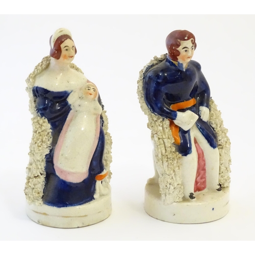 105 - A pair of Victorian Staffordshire pottery figures depicting Queen Victoria seated holding a child, a... 