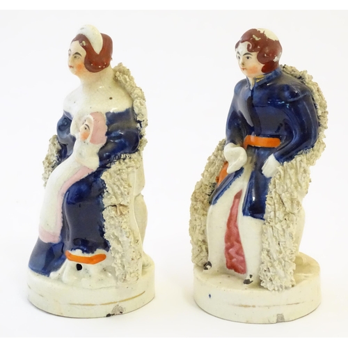 105 - A pair of Victorian Staffordshire pottery figures depicting Queen Victoria seated holding a child, a... 