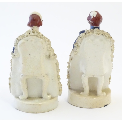 105 - A pair of Victorian Staffordshire pottery figures depicting Queen Victoria seated holding a child, a... 