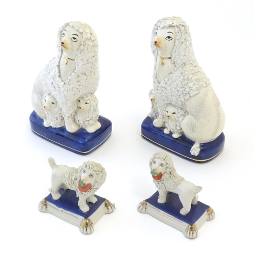 108 - A pair of Staffordshire pottery models of seated Poodle dogs with puppies, together with a pair of S... 