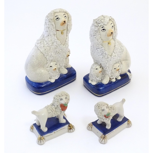 108 - A pair of Staffordshire pottery models of seated Poodle dogs with puppies, together with a pair of S... 