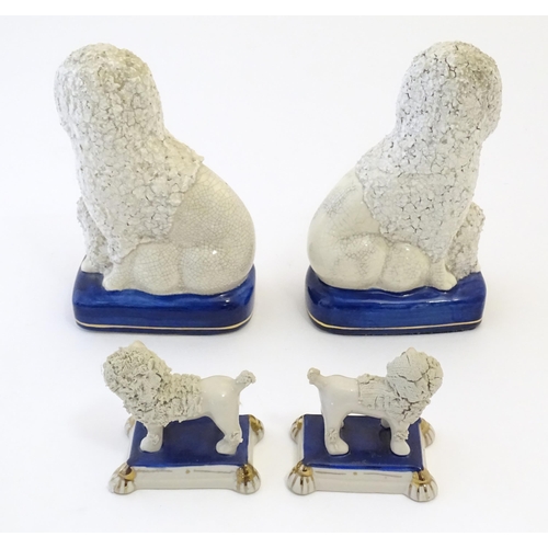 108 - A pair of Staffordshire pottery models of seated Poodle dogs with puppies, together with a pair of S... 