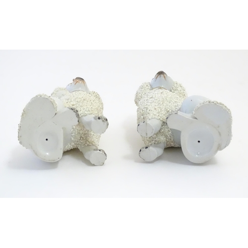 109 - A pair of Staffordshire pottery models of seated Poodle dogs with gilded collars. Approx. 5 1/2