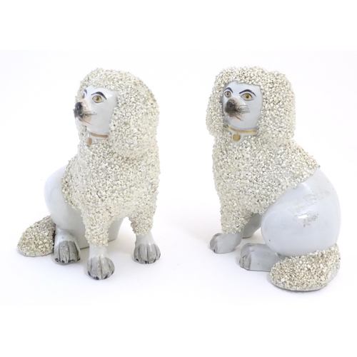 109 - A pair of Staffordshire pottery models of seated Poodle dogs with gilded collars. Approx. 5 1/2