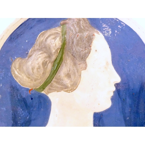 126 - A 19thC ceramic plaque by Conrad Dressler, depicting a profile portrait of a woman in relief, titled... 