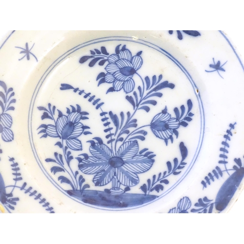 37 - A Chinese blue and white plate decorated with stylised flowers and foliage. Together with another de... 