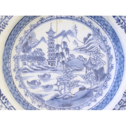 43 - Two Chinese blue and white dishes, one decorated with a river landscape depicting boats, pagoda styl... 