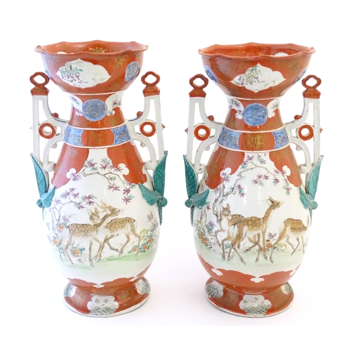 65 - A pair of Japanese vases with flared scallop edge rims and twin pierced handles with relief foliate ... 