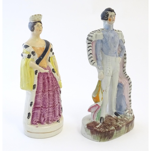 97 - Two Victorian Staffordshire pottery figures depicting Prince Albert, and Queen Victoria. Largest app... 