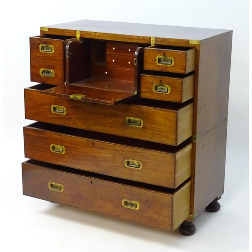 1937 - An early / mid 19thC mahogany campaign chest with brass caps and corner mounts, the chest comprising... 