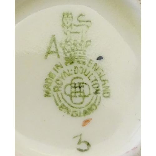 145 - A Royal Doulton small character jug modelled as Merlin, marked under D6536. Together with model of a... 