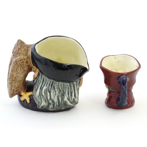 145 - A Royal Doulton small character jug modelled as Merlin, marked under D6536. Together with model of a... 