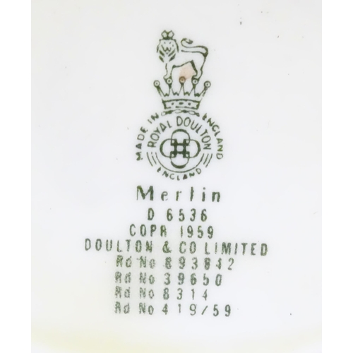 145 - A Royal Doulton small character jug modelled as Merlin, marked under D6536. Together with model of a... 