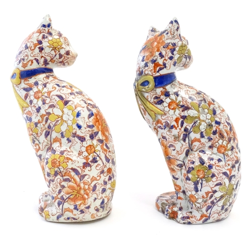 69A - A pair of Oriental models of cats decorated in the Imari palette with flowers, foliage and gilt high... 