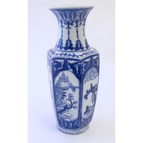 81 - An Oriental blue and white vase with panelled decoration depicting landscapes, birds perched on bran... 