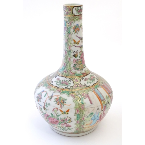 78 - A Chinese / Cantonese bottle vase with panelled decoration depicting figures on a garden terrace, fl... 