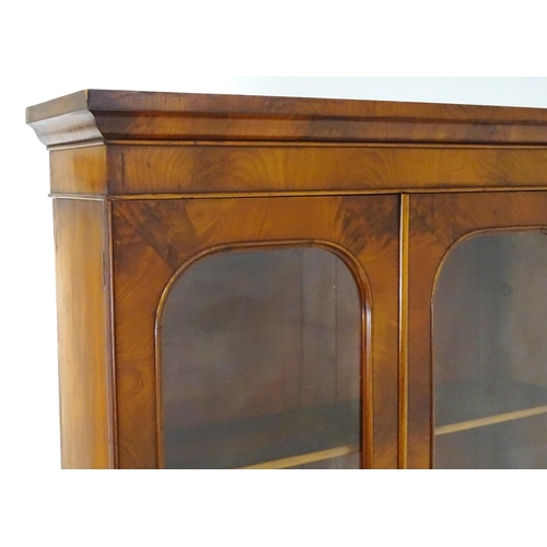 1940 - An early / mid 19thC mahogany bookcase of exceptional quality, having a moulded cornice above two gl... 