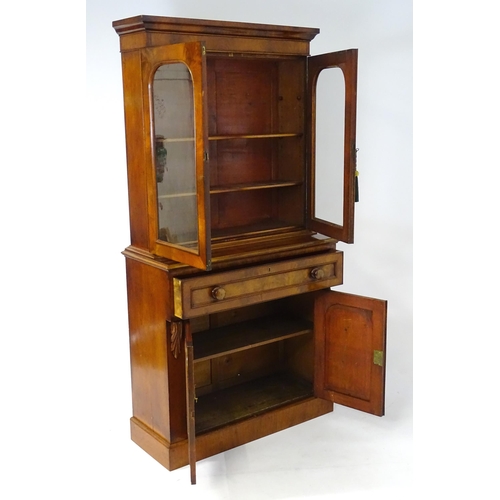 1940 - An early / mid 19thC mahogany bookcase of exceptional quality, having a moulded cornice above two gl... 