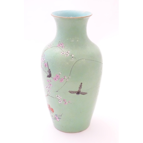 40 - A Chinese vase with incised detail to the pale green ground, decorated with birds in a tree with blo... 