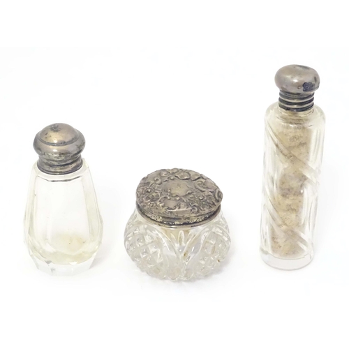 584 - Two small silver lidded glass scent / perfume bottles hallmarked London 1904 makers Henry Perkins & ... 