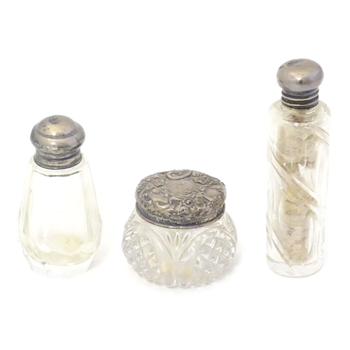 584 - Two small silver lidded glass scent / perfume bottles hallmarked London 1904 makers Henry Perkins & ... 