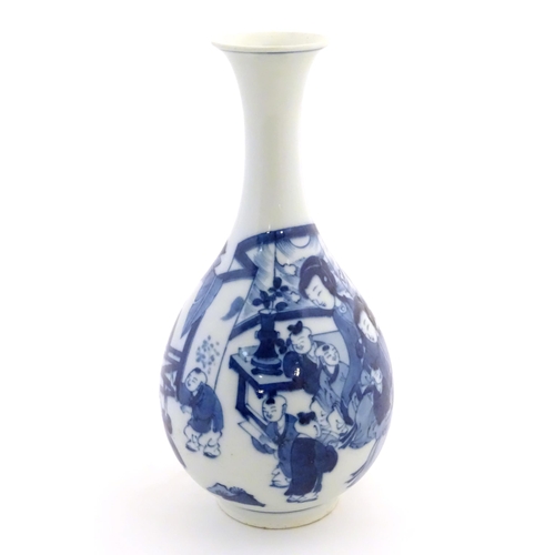 41 - An Oriental blue and white bottle vase with a flared rim decorated with two women and children in an... 