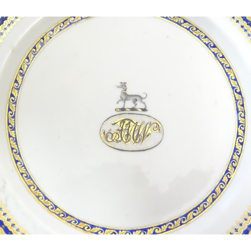 57 - A Chinese Export plate with long dog armorial and monogram under, with gilt leaf border. Approx. 7 1... 