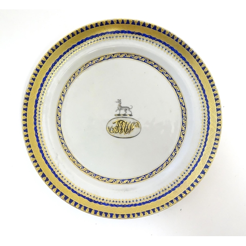 57 - A Chinese Export plate with long dog armorial and monogram under, with gilt leaf border. Approx. 7 1... 